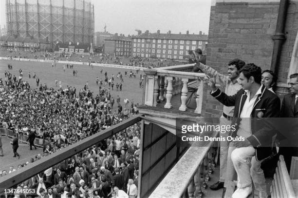 Ajit Wadekar team captain of India and bowler Bhagwath Chandrasekhar wave from the pavilion balcony to the crowd on the pitch below after India won...
