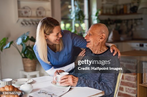Caregiver or healthcare worker visiting senior man at home. Caregiver or healthcare worker visiting senior man at home.