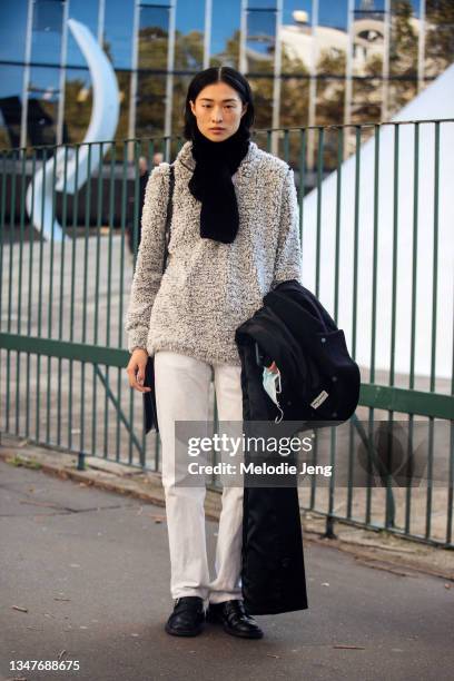 Model Ashley Radjarame wears a black leather jacket, purple zebra print top, blue jeans, black cowboy boots, and a black leather bag after the Stella...