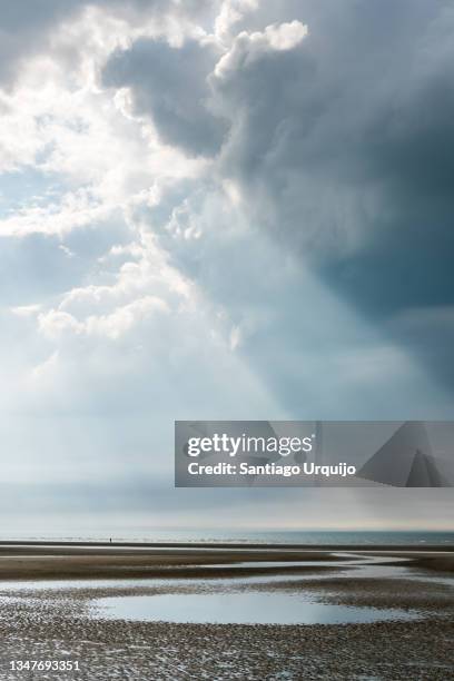 sunbeam over a beach - knokke belgium stock-fotos und bilder