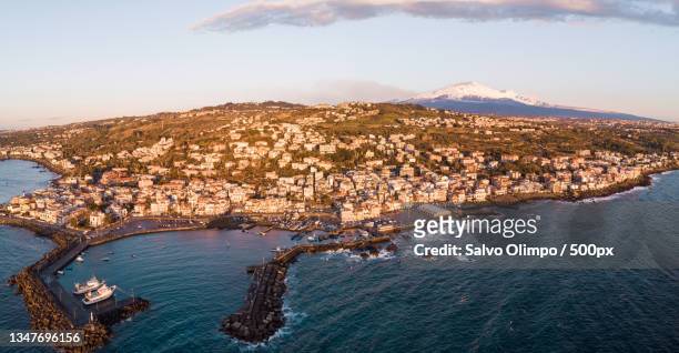 aerial view of sea and cityscape against sky,aci trezza,catania,italy - catania stock-fotos und bilder