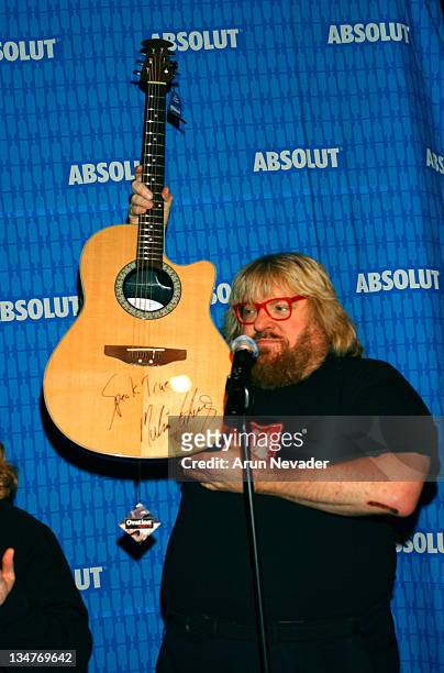 Bruce Vilanch auctioning a guitar signed by Melissa Etheridge