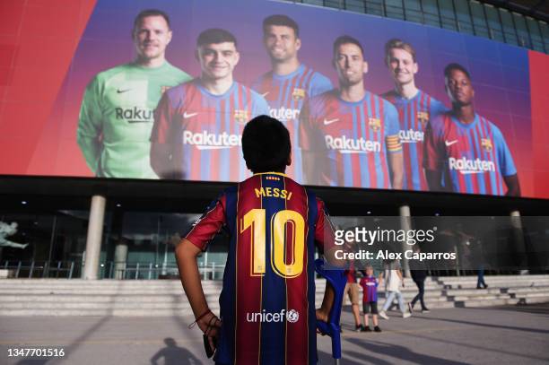 An FC Barcelona fan with a Lionel Messi printed shirt stands outside the stadium prior to the UEFA Champions League group E match between FC...