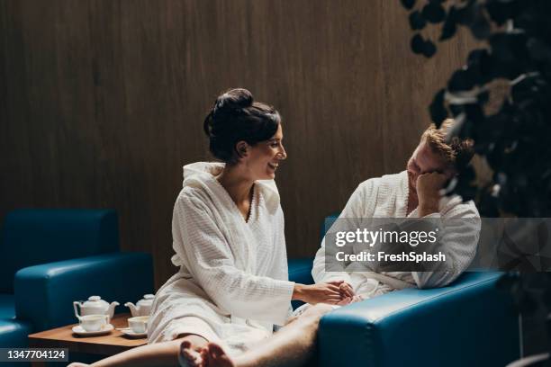 young couple relaxing at wellness spa center - bathrobe stock pictures, royalty-free photos & images