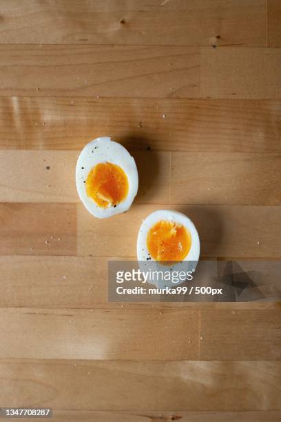 directly above shot of eggs on table - hard boiled eggs stock-fotos und bilder