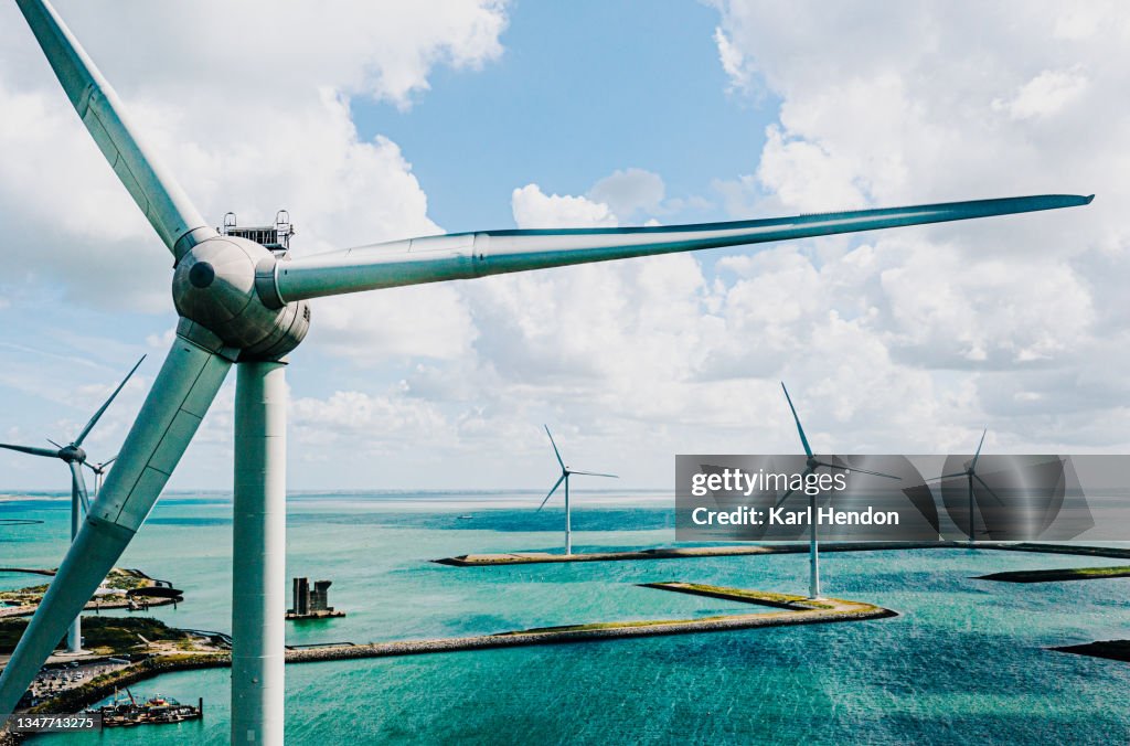 A close-up daytime aerial view of wind turbines - stock photo