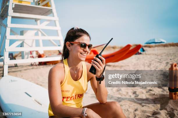 lifeguard using his talky walky,radio - lifeguard stock pictures, royalty-free photos & images