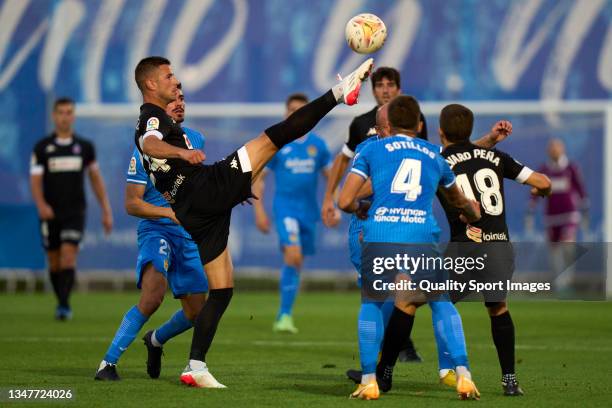 Roman Zozulya of CF Fuenlabrada battle for the ball with Gorka Guruzeta of SD Amorebieta during the LaLiga Smartbank match between CF Fuenlabrada and...