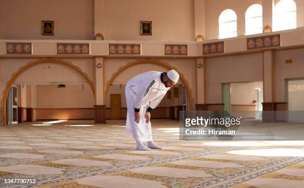 shot of a young muslim man praying in a mosque - bent stock pictures, royalty-free photos & images