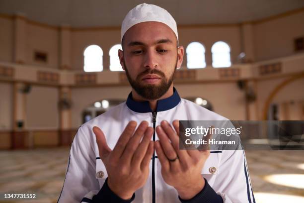 shot of a young muslim man holding up his hands while praying in a mosque - isfahan imam stock pictures, royalty-free photos & images