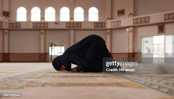 shot of a young muslim woman praying in a mosque - salat bildbanksfoton och bilder