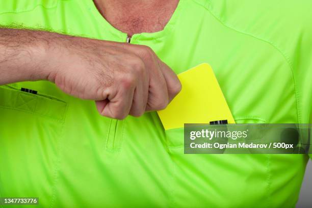 referee pulling a yellow card - spelregels stockfoto's en -beelden
