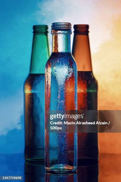 close-up of beer bottles against wall - bottle condensation stock pictures, royalty-free photos & images