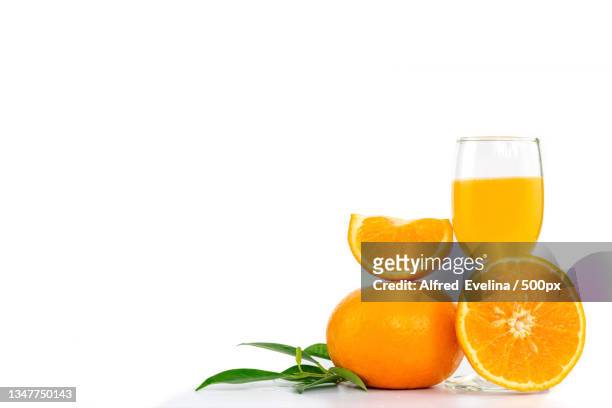 close-up of oranges with juice against white background - orange juice glass white background stock pictures, royalty-free photos & images