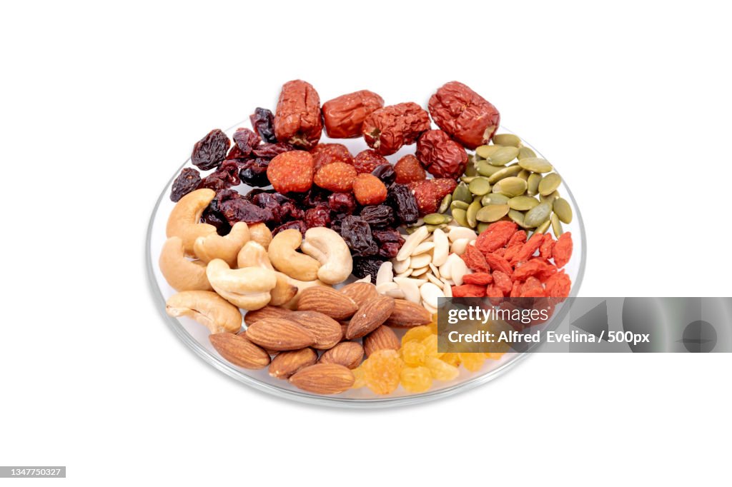 Close-up of dried food in bowl against white background