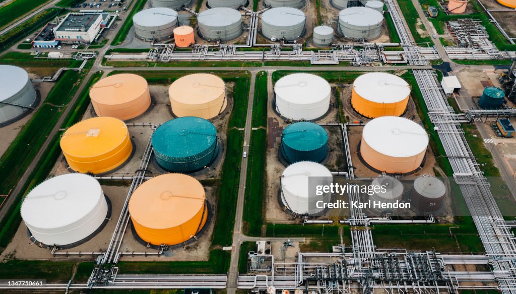 An aerial view of colourful storage tanks at a power station - stock photo