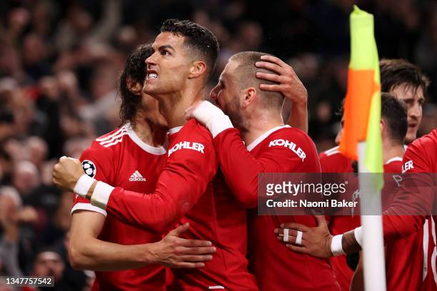Cristiano Ronaldo of Manchester United celebrates with teammates Luke Shaw and Edinson Cavani after scoring their side's third goal during the UEFA...
