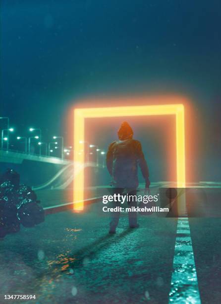 strange portals glows as man with a bag walks into it - glowing doorway stock pictures, royalty-free photos & images