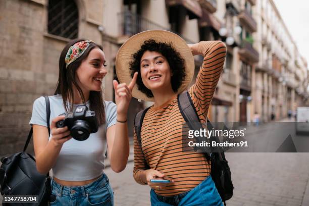 happy diverse lesbian couple on a vacation together - barcelona free stockfoto's en -beelden