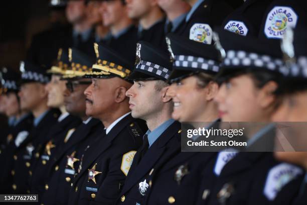 Chicago police officers pose for pictures at a Chicago Police Department promotion and graduation ceremony on October 20, 2021 in Chicago, Illinois....