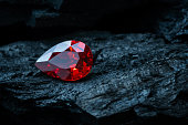 Red ruby on black coal background