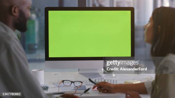 shot of a young businessman and businesswoman using a computer with a green screen in a modern office - computer monitor green screen stock pictures, royalty-free photos & images