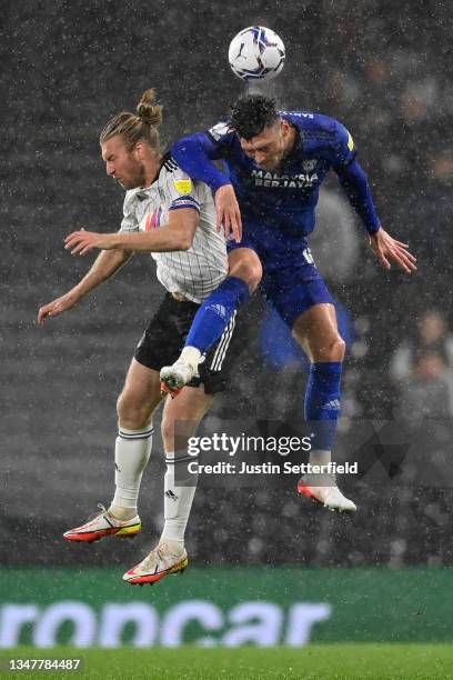 Tim Ream of Fulham challenges Kieffer Moore of Cardiff City during the Sky Bet Championship match between Fulham and Cardiff City at Craven Cottage...