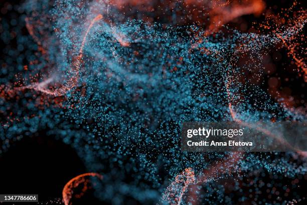 splash of many little blue and orange particles on black background. perfect backdrop for your design - leichtigkeit stock-fotos und bilder