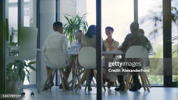 shot of a group of businesspeople having a meeting in a modern office - auditing bildbanksfoton och bilder