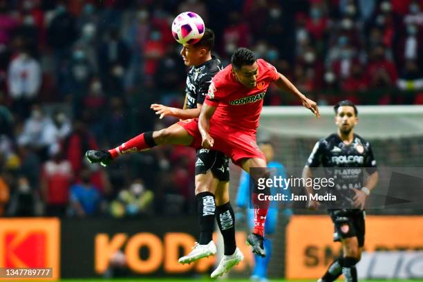 Fernando Ruben Gonzalez of Necaxa jumps for the ball with Jose Juan Vazquez of Toluca during the 14th round match between Toluca and Necaxa as part...