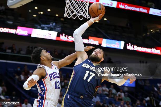 Jonas Valanciunas of the New Orleans Pelicans shoots against Tobias Harris of the Philadelphia 76ers during the first half at the Smoothie King...