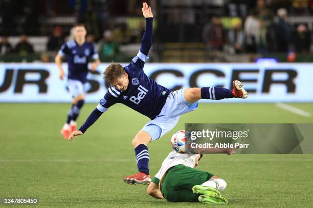 Ryan Gauld of the Vancouver Whitecaps collides with Cristhian Paredes of Portland Timbers during the first half at Providence Park on October 20,...