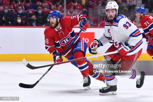 David Savard of the Montreal Canadiens skates against Mika Zibanejad of the New York Rangers in the NHL game at the Bell Centre on October 16, 2021...