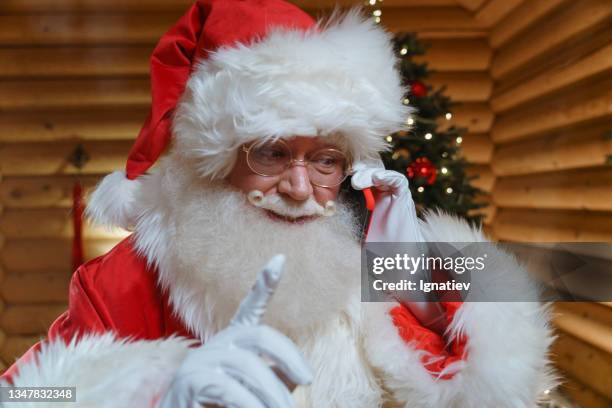 santa claus talking on a smartphone. sometimes even wizards use modern technology. - retirement invitation stock pictures, royalty-free photos & images