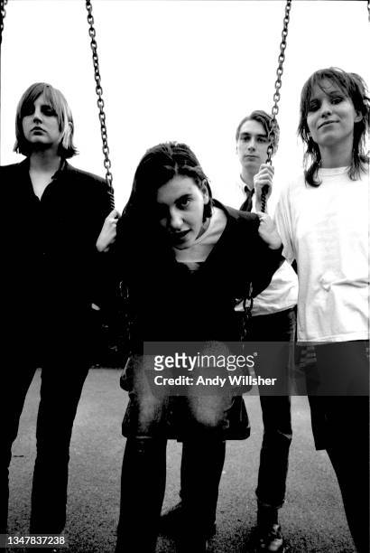 Group portrait of British band Elastica posing on a swing before a show at Bedford Esquires, Bedford, United Kingdom, 5th June 1993. L-R Donna...