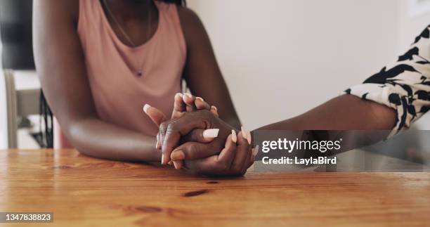 shot of an unrecognizable female comforting her mother at home - mourning imagens e fotografias de stock