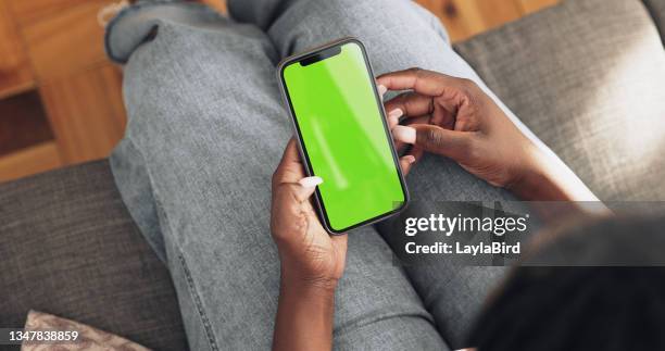 shot of a unrecognizable woman using her phone at home - green screen stock pictures, royalty-free photos & images
