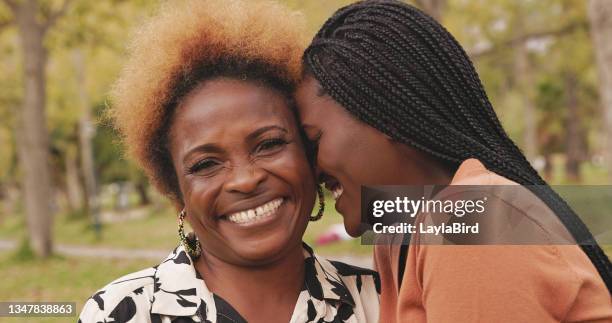 shot of a mature woman and her daughter standing in a park outside - young woman and senior lady in a park stock pictures, royalty-free photos & images