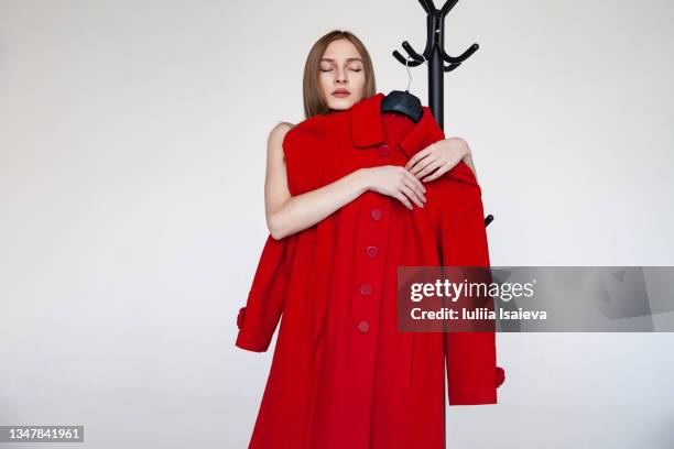 stylish woman with red coat in studio - giant woman ストックフォトと画像