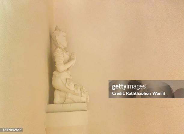 the beauty of the white-male thevada (angel) statue sitting and standing at thai temple. - theravada stock pictures, royalty-free photos & images