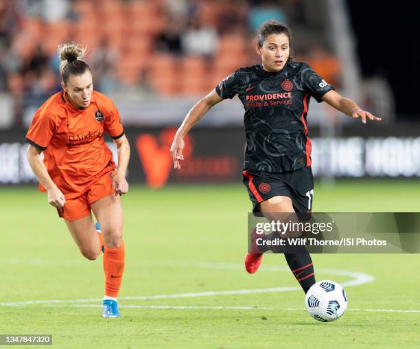 Rocky Rodriguez of the Portland Thorns FC brings the Gallup the field with Gabby Seiler of the Houston Dash chasing her during a game between...