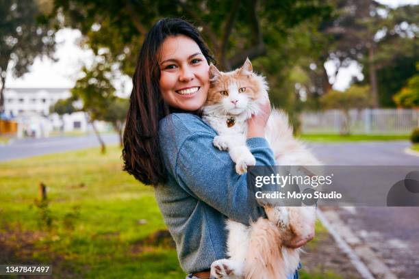 shot of a young woman bonding with her cat outside - cat studio shot stock pictures, royalty-free photos & images