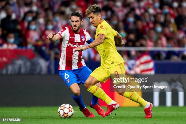 Koke of Atletico de Madrid battle for the ball with Roberto Firmino of Liverpool FC during the UEFA Champions League group B match between Atletico...