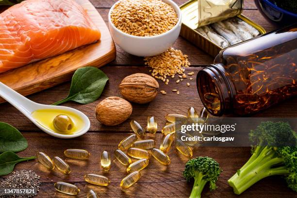 heart care diet: fish oil capsules and food rich in omega-3 - omega 3 stockfoto's en -beelden