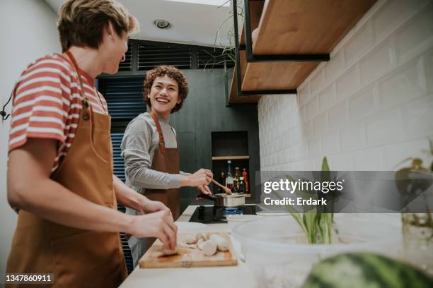 genderqueer friends sustainable cooking at home-stock photo - nb stock pictures, royalty-free photos & images