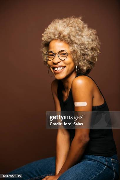 woman with band-aid after vaccination - name patch stock pictures, royalty-free photos & images