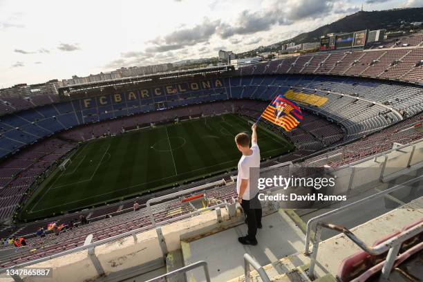 Fan waves a FC Barcelona flag as he arrives at the stadium prior to the UEFA Champions League group E match between FC Barcelona and Dinamo Kiev at...