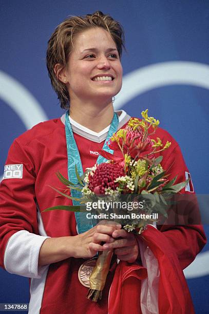 Bronze medalist Anne Montminy of Canada smiles on the podium after the Women's 10m Platform Final during the Sydney 2000 Olympic Games on September...