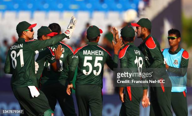 Mohammad Naim of Bangladesh is congratulated after taking a catch to dismiss Charles Amini of Papua New Guinea during the ICC Men's T20 World Cup...