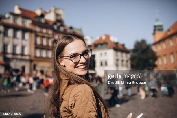 woman smiling at the camera. - daily life in warsaw poland stock-fotos und bilder